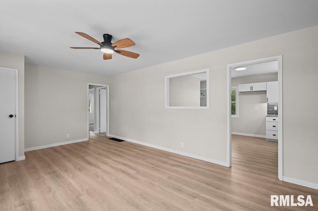 3040 Oak Street Ct, Bettendorf, IA 52722 - empty room with light wood-style floors and a ceiling fan