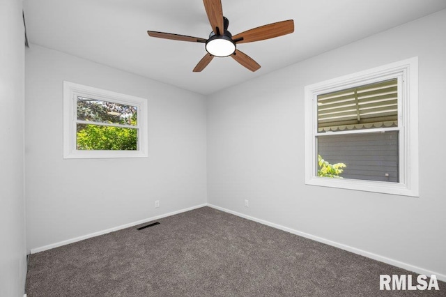 3040 Oak Street Ct, Bettendorf, IA 52722 - spare room with dark colored carpet and ceiling fan