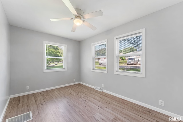 115 4th St, Colona, IL 61241 - empty room with light wood finished floors and a ceiling fan
