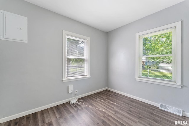 115 4th St, Colona, IL 61241 - empty room featuring wood finished floors and electric panel