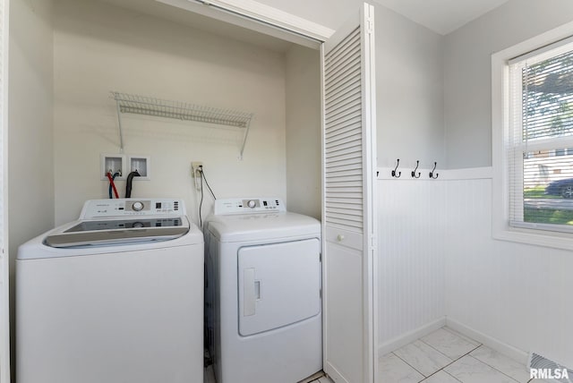 115 4th St, Colona, IL 61241 - laundry area with washing machine and dryer, light marble finish flooring, and wainscoting