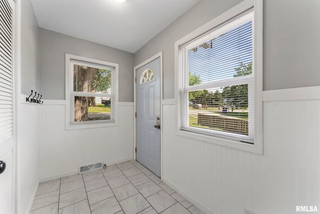 115 4th St, Colona, IL 61241 - doorway with wainscoting and light marble finish flooring