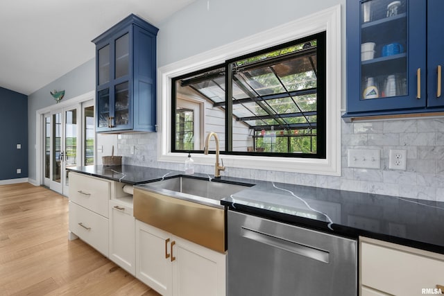 223 N 2nd St, Le Claire, IA 52753 - kitchen featuring stainless steel dishwasher, blue cabinetry, decorative backsplash, and light wood finished floors