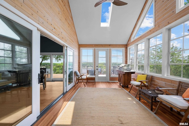 223 N 2nd St, Le Claire, IA 52753 - sunroom with wood finished floors, healthy amount of natural light, wooden walls, and high vaulted ceiling