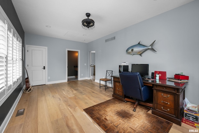 223 N 2nd St, Le Claire, IA 52753 - office area featuring baseboards and light wood finished floors
