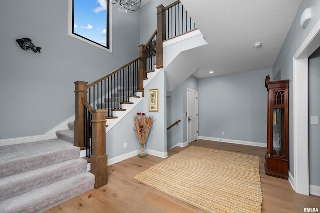223 N 2nd St, Le Claire, IA 52753 - stairway featuring wood finished floors and a chandelier