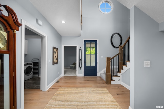 223 N 2nd St, Le Claire, IA 52753 - foyer featuring washer / dryer, stairway, light wood finished floors, recessed lighting, and a textured ceiling
