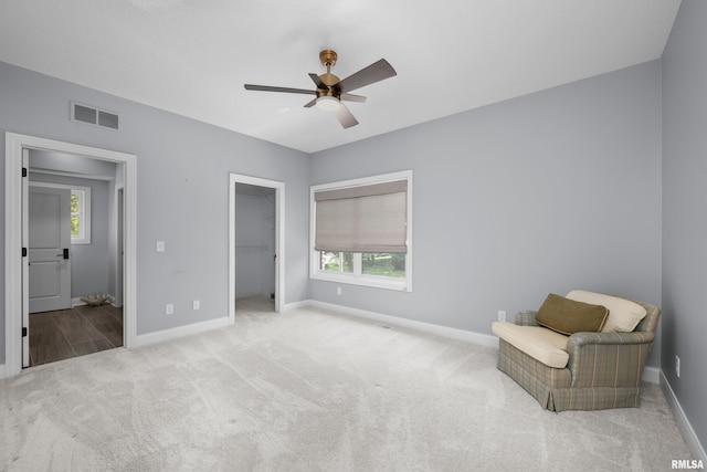 223 N 2nd St, Le Claire, IA 52753 - carpeted bedroom with multiple windows, a spacious closet, ceiling fan, and a closet