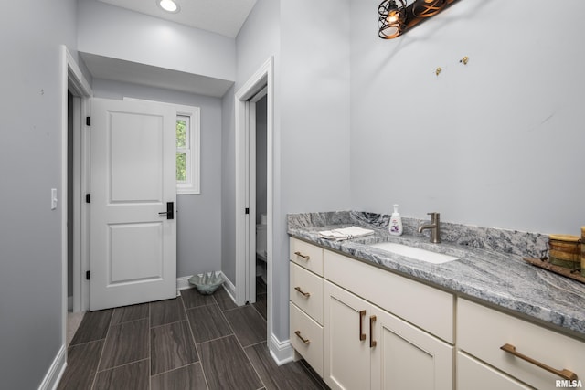 223 N 2nd St, Le Claire, IA 52753 - bathroom featuring vanity and wood tiled floors