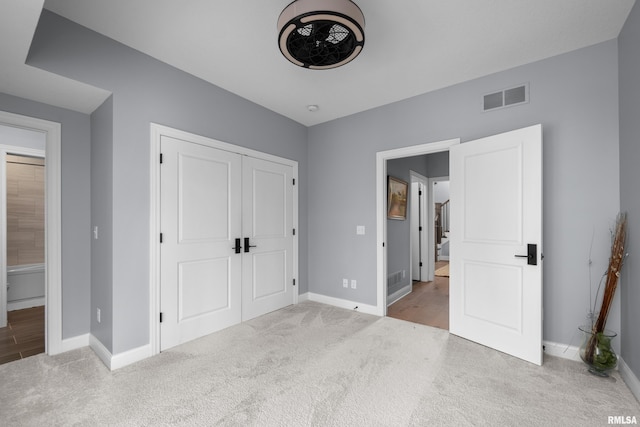 223 N 2nd St, Le Claire, IA 52753 - unfurnished bedroom featuring carpet and a closet