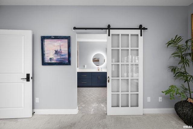223 N 2nd St, Le Claire, IA 52753 - bedroom with light carpet, a barn door, and ensuite bath