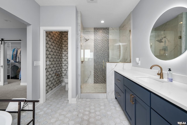223 N 2nd St, Le Claire, IA 52753 - bathroom featuring a shower stall, vanity, a walk in closet, tile patterned flooring, and recessed lighting