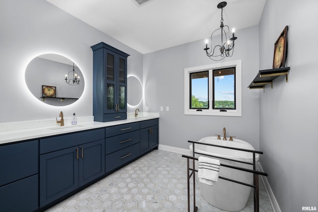 223 N 2nd St, Le Claire, IA 52753 - full bathroom with a chandelier, double vanity, and a soaking tub