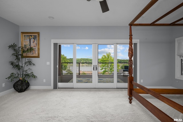 223 N 2nd St, Le Claire, IA 52753 - unfurnished living room with carpet flooring, a ceiling fan, a water view, and french doors