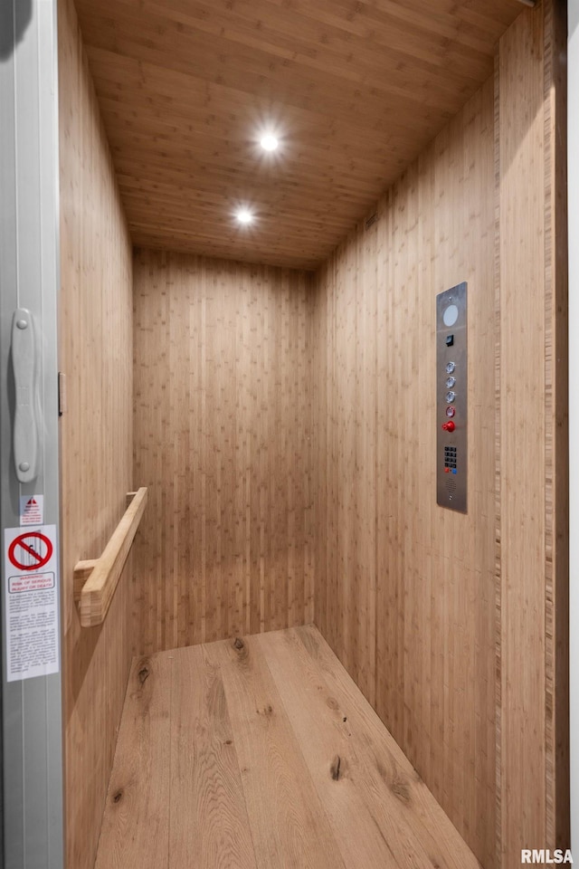 223 N 2nd St, Le Claire, IA 52753 - elevator with wooden ceiling and wood walls