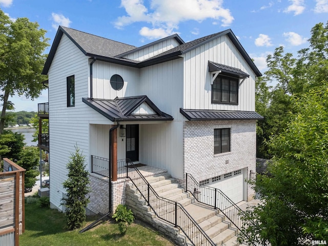 223 N 2nd St, Le Claire, IA 52753 - modern inspired farmhouse featuring a standing seam roof, an attached garage, a metal roof, and stairs