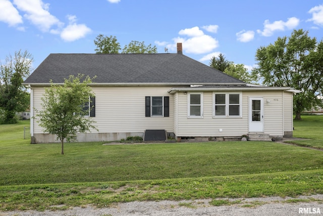 406 234th St, Aledo, IL 61231 - back of property featuring entry steps, a chimney, a shingled roof, and a yard