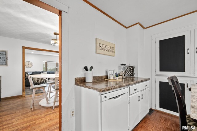 406 234th St, Aledo, IL 61231 - kitchen featuring dishwasher, light wood-style floors, dark countertops, ornamental molding, and white cabinetry
