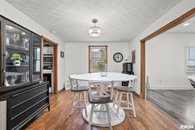 406 234th St, Aledo, IL 61231 - dining space featuring dark wood-style flooring and a chandelier