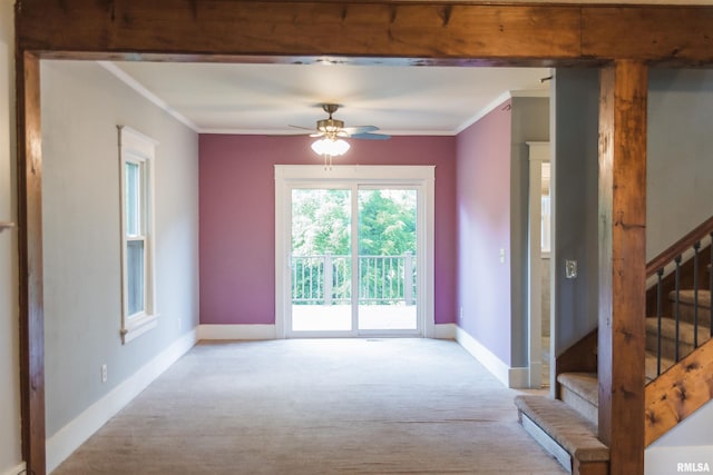 3321 State St, Quincy, IL 62301 - carpeted empty room with ornamental molding, ceiling fan, and stairway