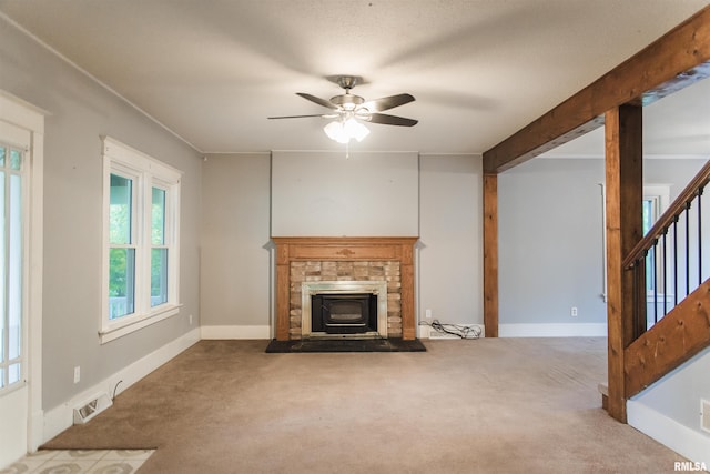 3321 State St, Quincy, IL 62301 - unfurnished living room with carpet, ceiling fan, stairway, and a fireplace with raised hearth