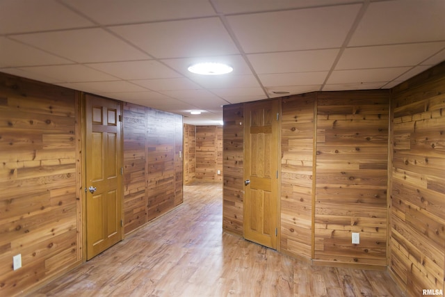 3321 State St, Quincy, IL 62301 - empty room featuring light wood-type flooring, wooden walls, and a drop ceiling