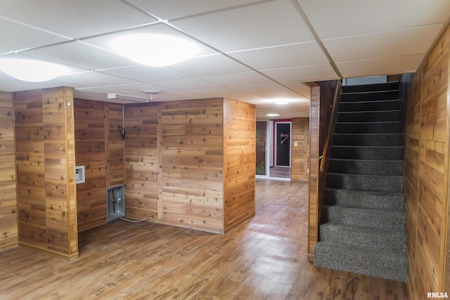 3321 State St, Quincy, IL 62301 - finished below grade area with wooden walls, stairway, light wood-style flooring, and a drop ceiling