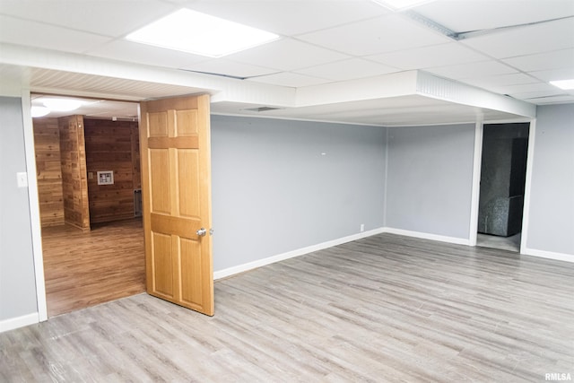 3321 State St, Quincy, IL 62301 - finished below grade area with a paneled ceiling, light wood-style flooring, and wood walls