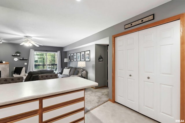 109 E Price St Unit 203, Eldridge, IA 52748 - kitchen featuring light countertops, open floor plan, white cabinetry, and ceiling fan