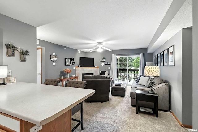 109 E Price St Unit 203, Eldridge, IA 52748 - living room with ceiling fan, a tile fireplace, and light colored carpet