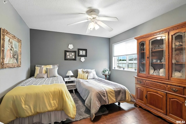 109 E Price St Unit 203, Eldridge, IA 52748 - bedroom featuring dark wood-type flooring, a textured ceiling, and ceiling fan