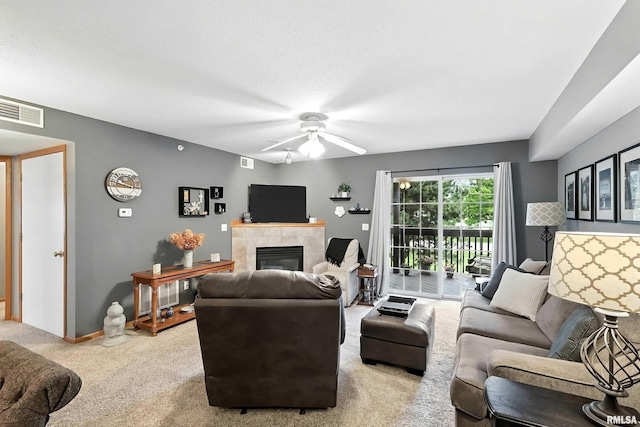 109 E Price St Unit 203, Eldridge, IA 52748 - carpeted living room featuring a fireplace and ceiling fan