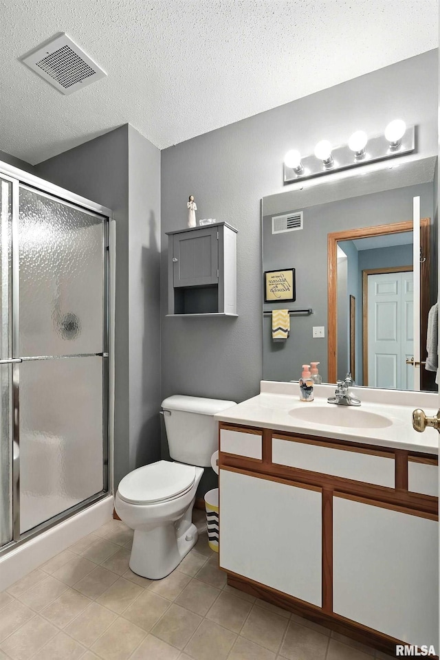 109 E Price St Unit 203, Eldridge, IA 52748 - bathroom featuring vanity, a stall shower, a textured ceiling, and tile patterned flooring