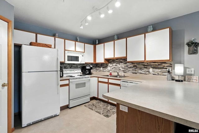 109 E Price St Unit 203, Eldridge, IA 52748 - kitchen featuring white appliances, light countertops, backsplash, white cabinetry, and a peninsula