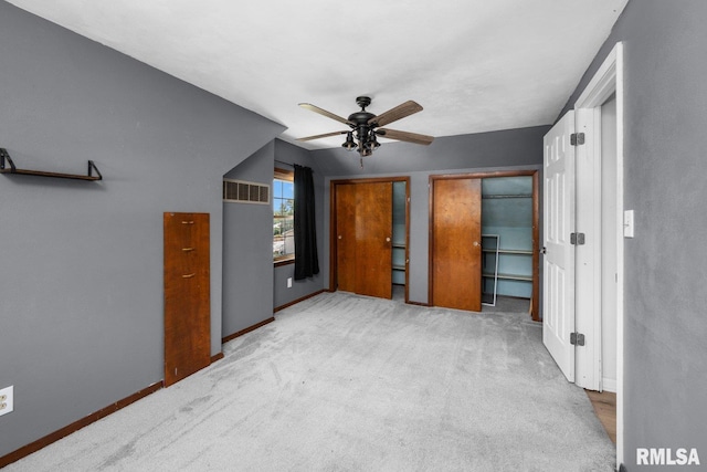 2207 4th St Unit A, East Moline, IL 61244 - unfurnished bedroom featuring carpet floors and a ceiling fan