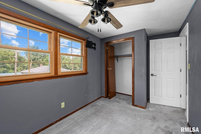 2207 4th St Unit A, East Moline, IL 61244 - unfurnished bedroom featuring light carpet, a closet, and ceiling fan