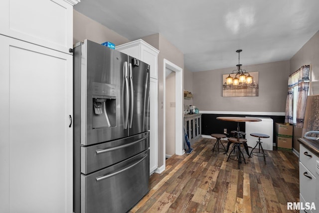 2207 4th St Unit A, East Moline, IL 61244 - kitchen with stainless steel refrigerator with ice dispenser, white cabinets, a chandelier, dark wood-style flooring, and pendant lighting