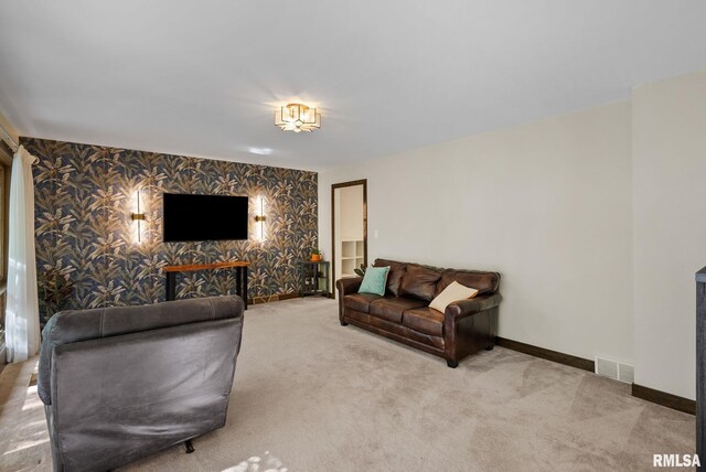17 Wildwood Trl, Bettendorf, IA 52722 - living room featuring wallpapered walls, carpet, and an accent wall