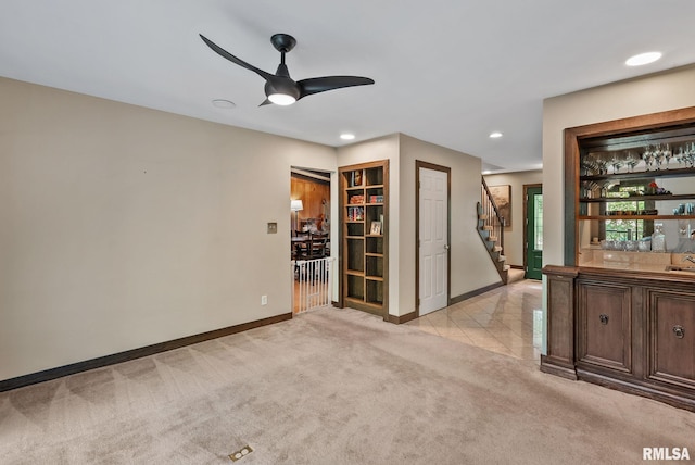 17 Wildwood Trl, Bettendorf, IA 52722 - unfurnished room featuring light carpet, stairs, ceiling fan, bar, and recessed lighting