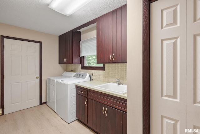 17 Wildwood Trl, Bettendorf, IA 52722 - laundry room featuring cabinet space, separate washer and dryer, and light wood-style flooring
