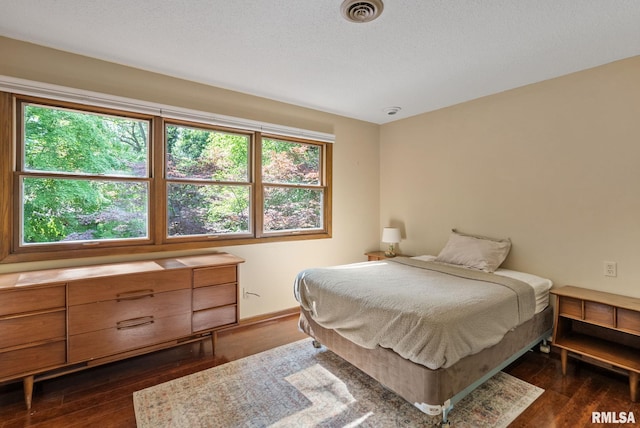 17 Wildwood Trl, Bettendorf, IA 52722 - bedroom with dark wood-type flooring and baseboards