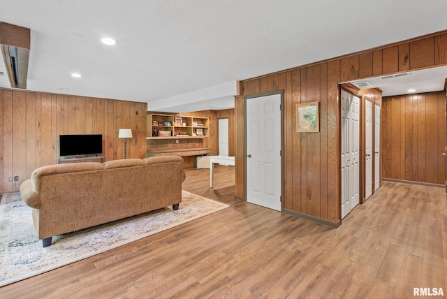 17 Wildwood Trl, Bettendorf, IA 52722 - living room featuring wooden walls, light wood-type flooring, and recessed lighting