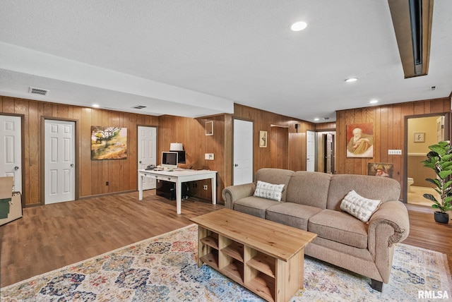 17 Wildwood Trl, Bettendorf, IA 52722 - living area featuring wooden walls, wood finished floors, and recessed lighting