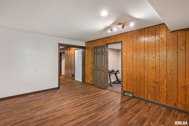 17 Wildwood Trl, Bettendorf, IA 52722 - unfurnished room with track lighting, wood finished floors, and wood walls