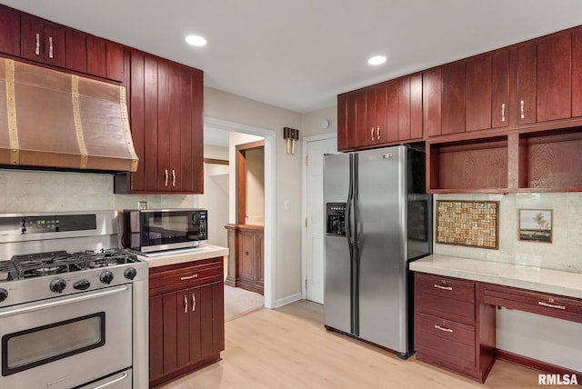 17 Wildwood Trl, Bettendorf, IA 52722 - kitchen featuring stainless steel appliances, ventilation hood, light wood-style floors, backsplash, and recessed lighting
