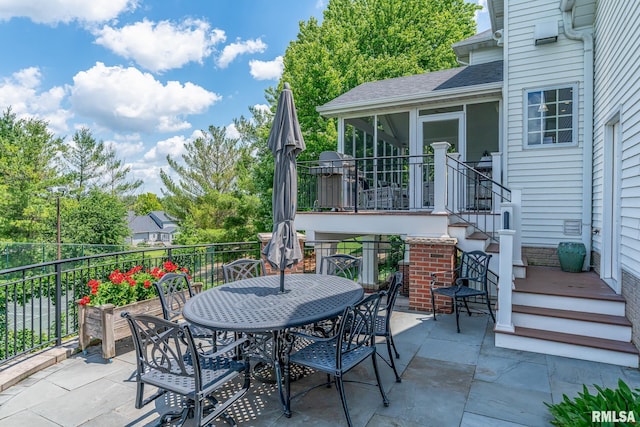 2806 E 42nd Ct, Davenport, IA 52807 - view of patio / terrace featuring a sunroom and outdoor dining area