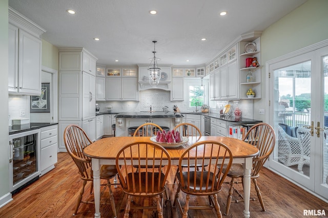 2806 E 42nd Ct, Davenport, IA 52807 - dining space with wine cooler, light wood finished floors, recessed lighting, and a chandelier