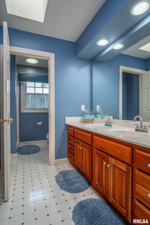2806 E 42nd Ct, Davenport, IA 52807 - full bathroom with double vanity and a skylight