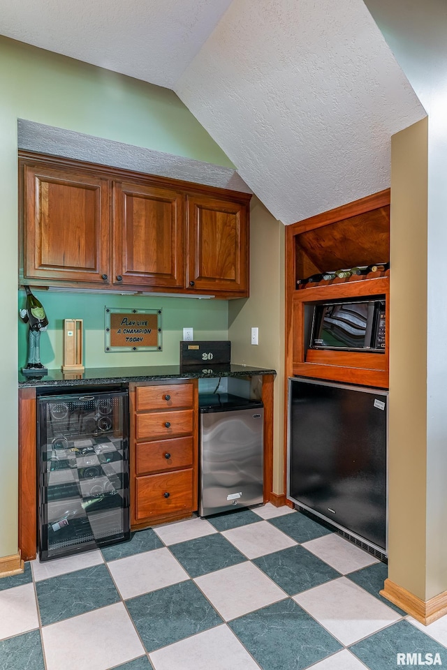 2806 E 42nd Ct, Davenport, IA 52807 - indoor dry bar with wine cooler, fridge, vaulted ceiling, light floors, and a textured ceiling