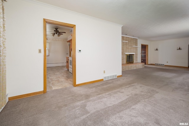 1635 Eastmere Dr, Davenport, IA 52803 - unfurnished living room with carpet floors, crown molding, a baseboard radiator, a fireplace, and a ceiling fan